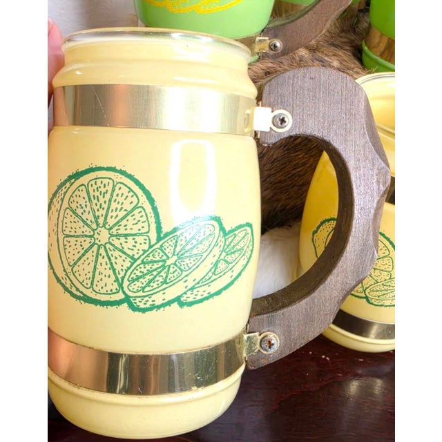 Set of 6 mugs—3 green and 3 yellow—with wooden handles, in very good condition.no damaged