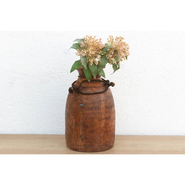 Originally used in village homes for storing milk, ghee, or grains, this antique wooden pot has survived generations of...