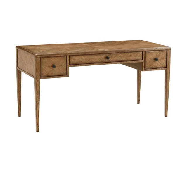 An Italian NeoClassic style starburst pattern parquetry desk with tapered legs. It has one center drawer flanked by two...