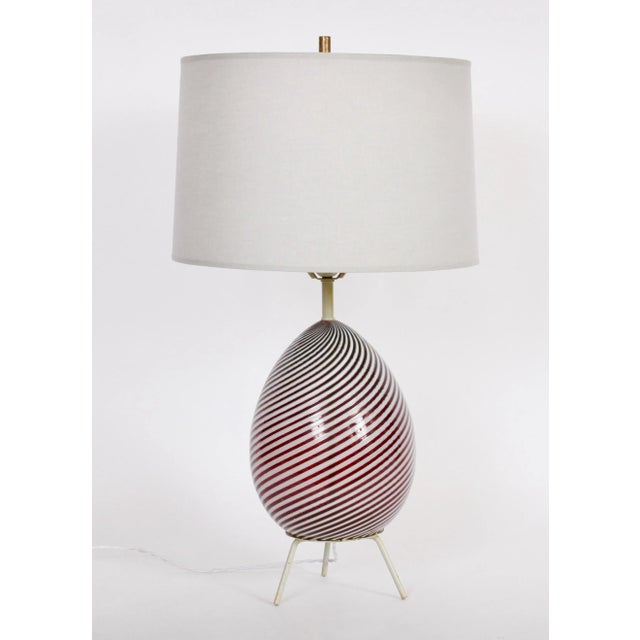 Dino Martens for Aureliano Toso deep cranberry and opaque white swirl Murano Glass Table Lamp, 1960s. Featuring a...