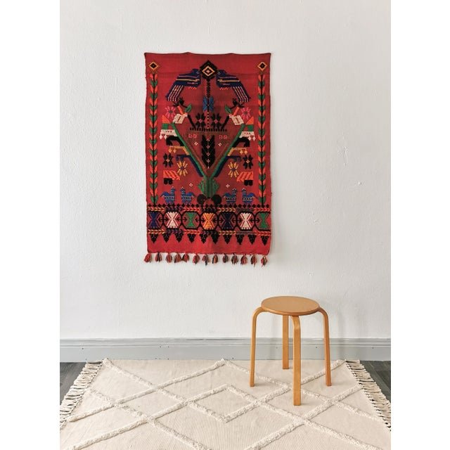 This tapestry was made from wool in Mexico in the 1970s. The high-quality, handmade knotted rug has a color scheme of red,...