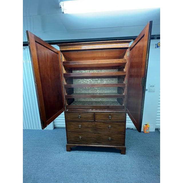 Antique George III linen press, comes apart in two pieces. Original tag on the lower case traces the provenance back to...