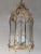 Petit Trianon style hexagonal polished brass hanging lantern. The lantern top is adorned with acanthus leaves and draped...