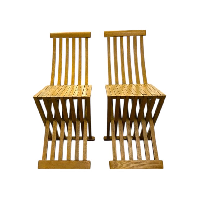 The Tomasa chair is made of slats of waxed oak, and threaded brass inserts, allowing for the chair to fold flat. The chair...