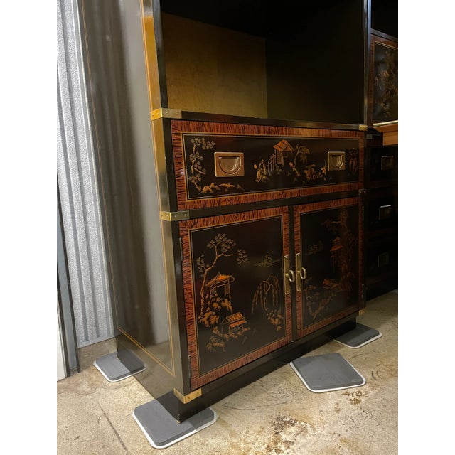 Circa 1960’s chinoiserie lacquered bookcase with one drawer and double doors. These are so incredibly beautiful! The brass...