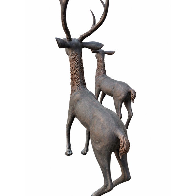 Impressive cast bronze stag and doe garden sculpture set with exceptional scale, beautifully modeled details, and a rich...