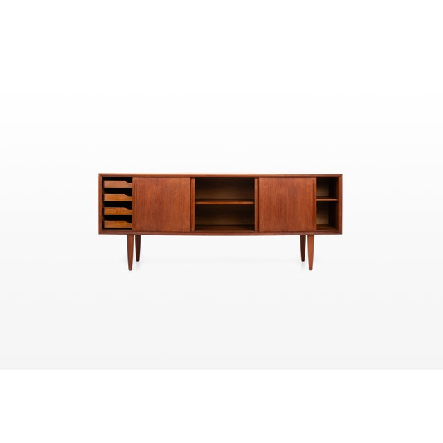 An elegant danish vintage sideboard in teak by h.p. Hansen, featuring a gently bowed front and beautifully balanced...