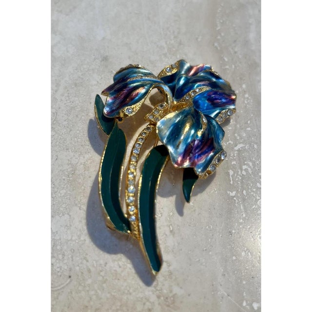 This vintage brooch takes the form of an iris in full bloom, its ruffled petals rendered in richly enameled layers of...