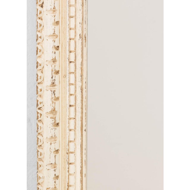 Rustic White Painted Wood Framed Mirror. Mirror plate: 21.75" H x 15.25" W; frame: 27.25" H x 21.25" W x 2" D. Provenance:...