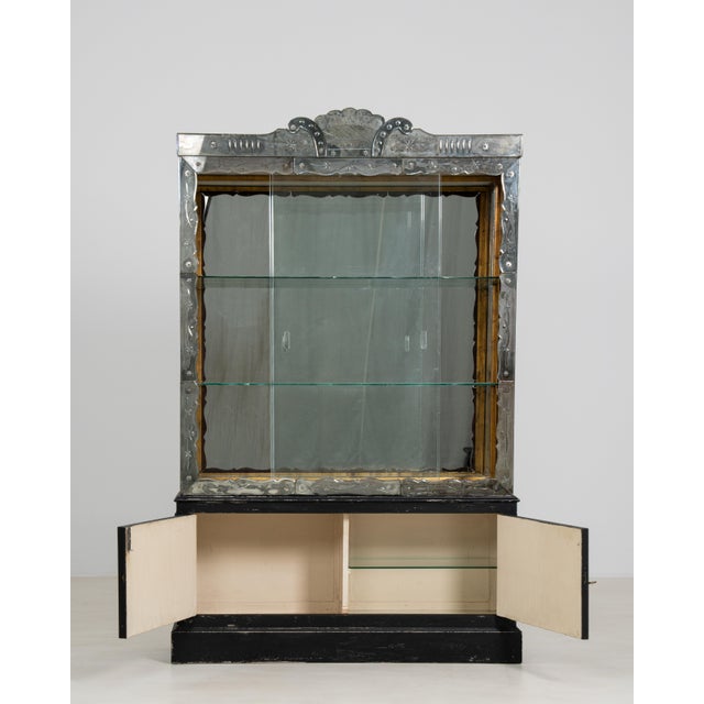 An elegant Venetian vitrine crafted in Italy in the 1950s. The cabinet features a wooden frame with glass panels on all...