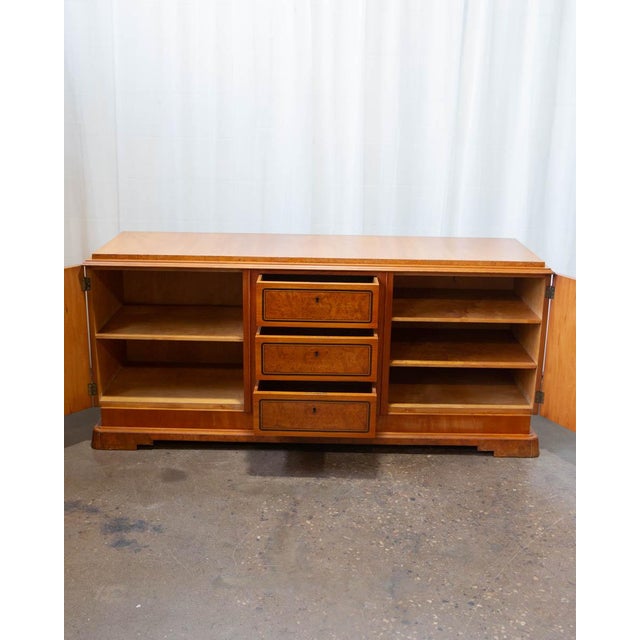 A large and beautifully figured Art Deco Swedish burlwood sideboard, produced in the 1930s during one of the most...