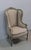 Louis XVI style wing chair. Its frame, sculpted on all its visible sides, displays a decoration of rose buds in the upper...