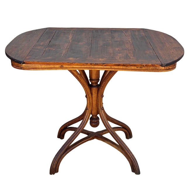 Rare late Victorian polished bent oak dining table by Mundus Thonet crafted from warm-toned bentwood with striking fluid...