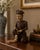Polychrome Wood with Gilt Accents | 20th Century This expressive hand-carved Chinese figural sculpture depicts a seated...