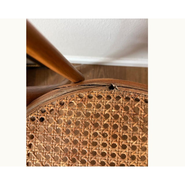 Classic bentwood café chair with a looped back, curved arms, and original cane seat. Thonet No. 18 style — one of the most...
