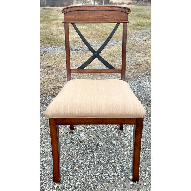 Rustic European styled set of four X back dining chairs by Lane Furniture. Nicely carved top rail above the iron X back....