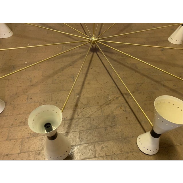 very rare hotel chandelier, produced by Stilnovo in the 50s, it has 12 arms with cones, and 24 light points, they come...