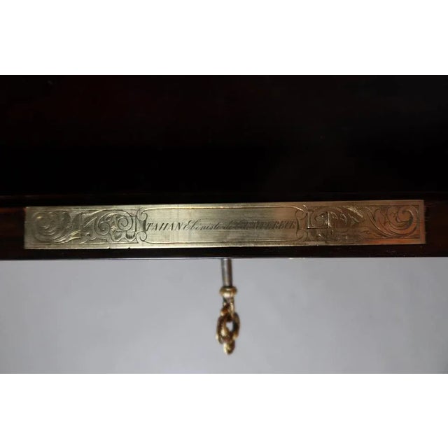 Small marquetry table signed Tahan cabinetmaker of the emperor in Paris opening by a slaughter discovering lockers and a...