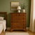 An elegant vintage tallboy dresser crafted from solid pine, featuring a warm wood finish, classic Shaker-style rounded...