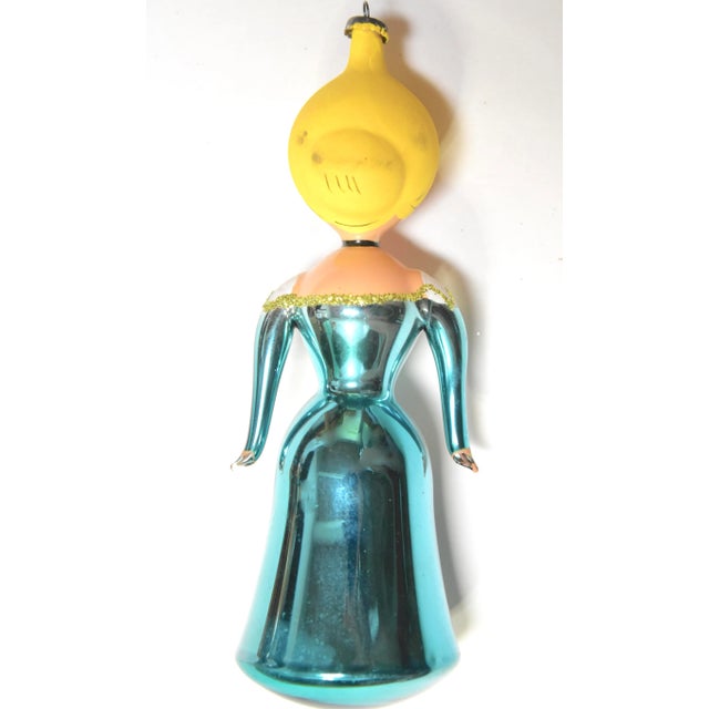 Free blown figurative glass ornament, exquisitely hand-painted details and glitter accents. Marked "Italy" on metal cap.