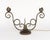 An antique (or near-antique) table lamp in the form of a candelabra, with two decorative hand-wrought symmetrical scrolled...