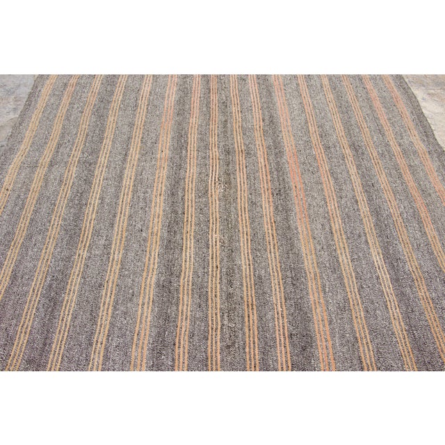 Handwoven in pure goat hair and originating circa 1950-1959, this 7x10 vintage Turkish kilim rug joins Rug & Kilim’s Kilim...