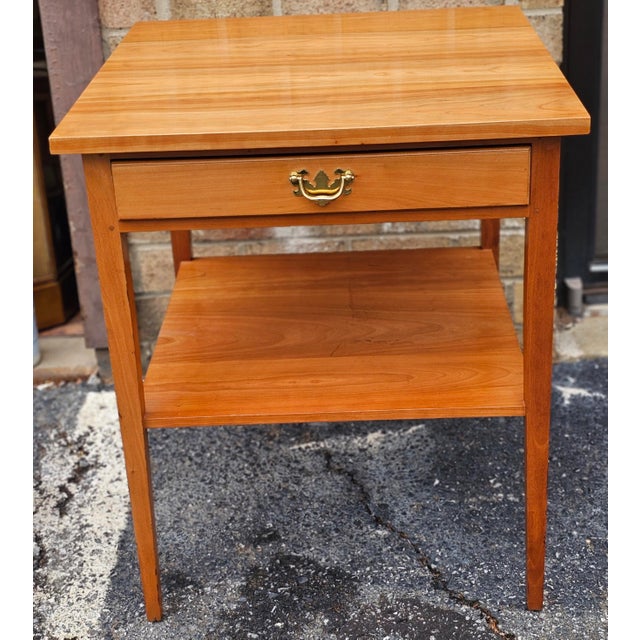 A late 20th Century Suters Reproductions Federal Style Solid Cherry Single Drawer Side Table. Measures 24" in width, 24"...