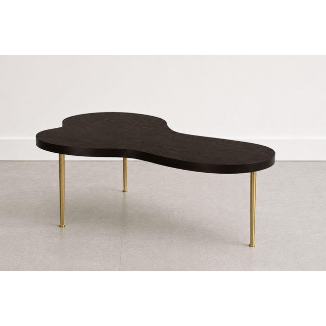 An iconic design by T.H. Robsjohn-Gibbings for Widdicomb (1950, USA), this sculpted walnut and brass Freeform cocktail...