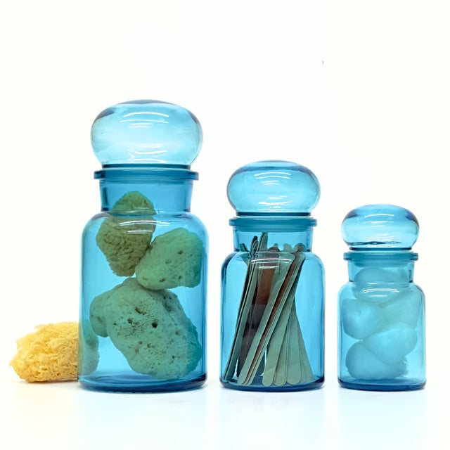Turquoise glass containers, group of 3. A retro set of turquoise-blue mid-century apothecary dome-lidded jars in various...