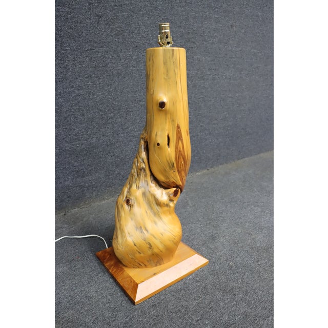 Mid century modern table lamp crafted from a sculptural piece of natural driftwood, mounted on a solid wood base. The form...
