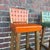 This pair of Ranch Oak bar stools have orange and green genuine leather seats with wrapped tasseled corners and woven seat...