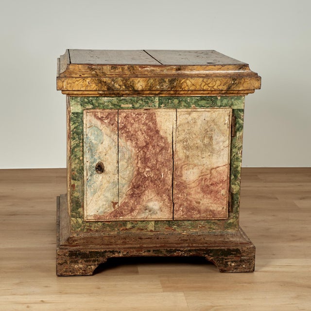 Charming 18th century Italian pedestal cabinet handcrafted in walnut with a door in front retaining the original key,...