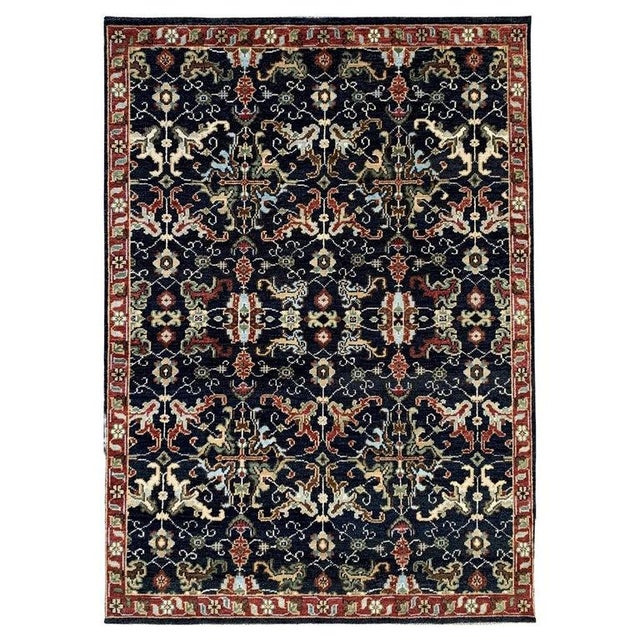 This blue wool rug features a hand knotted pile weave designed for durability and classic appeal. It is a traditional area...