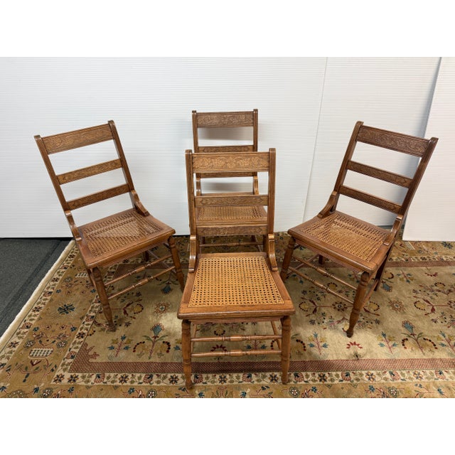 Design Plus Gallery presents a Set of Four Antique Ladder-back Dining Room Chairs from the Victorian Era. The chairs have...
