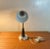 This desk lamp from the 1960s was designed in the 1960s. It features a chrome-plated flexible arm, a grey metal base and...