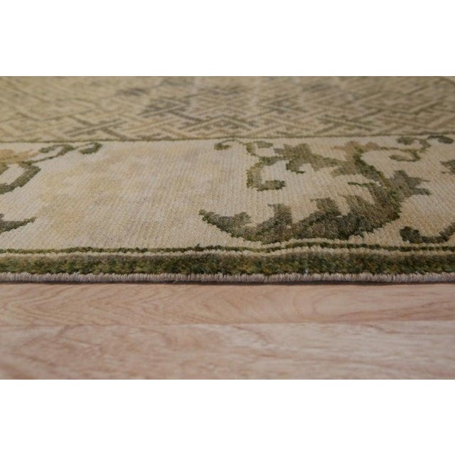 This hand knotted pile rug features a primary green color and is constructed from durable wool. Originating from China,...