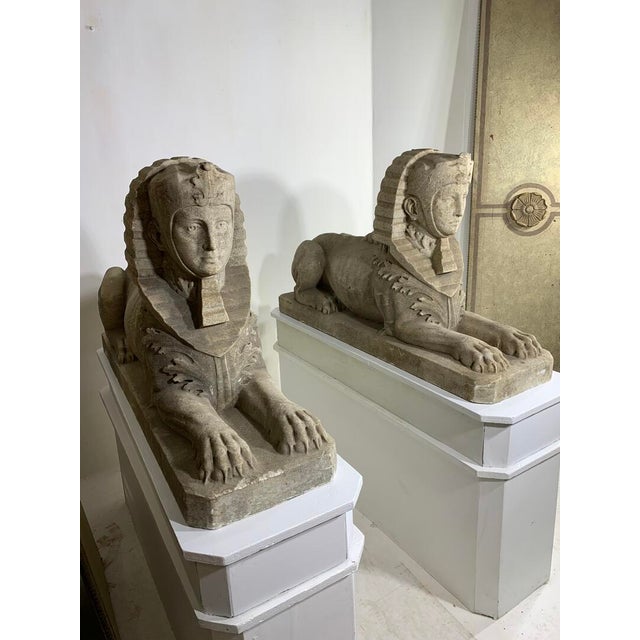Large Identical pair of weathered white marble sphinxes with idealized female faces. Now on modern, custom wood pedestals,...