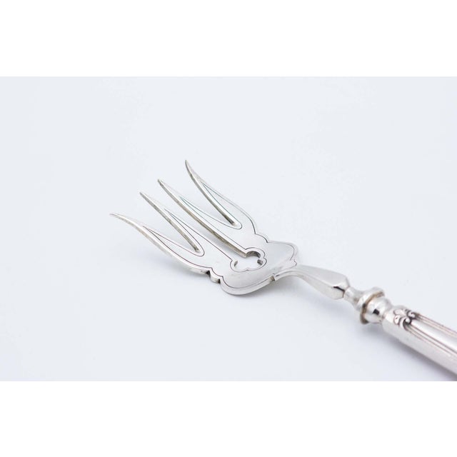 Silver Fish Serving Fork with Engravings, Cutouts, Relief and Shell-Shaped Handle, in Very Good conditions. Designed 1920...