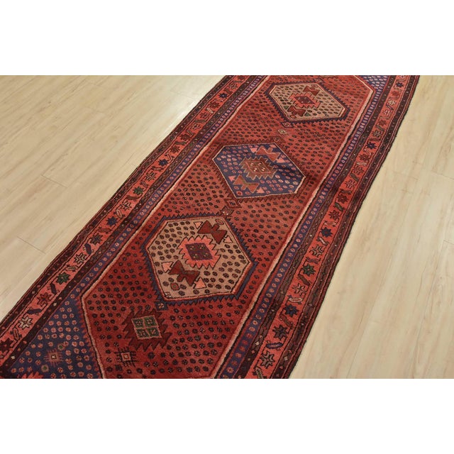 An authentic vintage tribal Zanjan runner hand-knotted with fine wool and natural dyes. This nomadic oriental rug features...