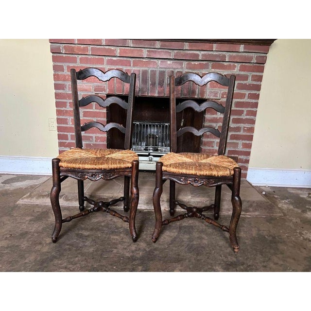 19th Century Pair of Antique French Provincial Style Oak Rush Seat Side Chairs. Well made with carved apron with floral...