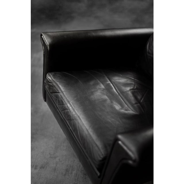 This rare office armchair was designed by the Danish designer Georg Thams during the 1960s. It is upholstered in black...