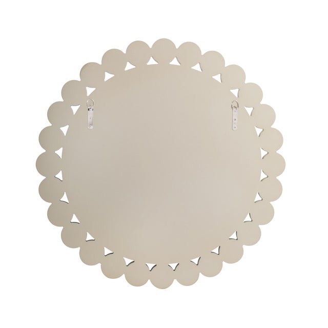 The mirror is framed by a ring of smaller circular mirrors, forming a layered design that adds texture, depth, and subtle...