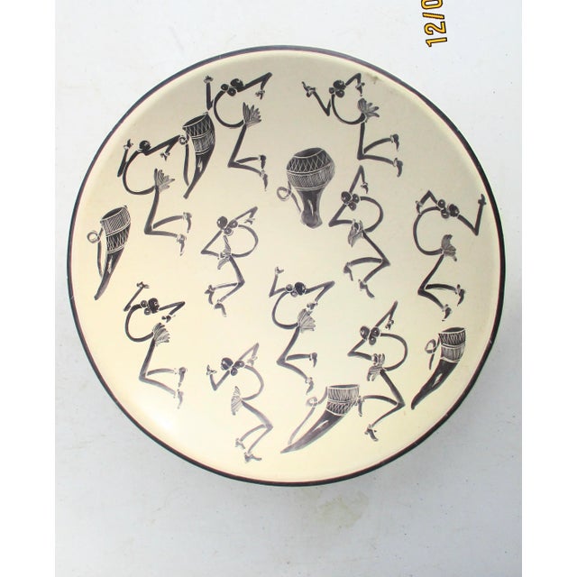 Hand-drawn sketches of jazz dancers reduced to almost musical note bodies. All moving around the bowl with various drums,...