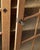 A tall Danish oak bookcase cabinet from the 1970s, with two glass-front doors and adjustable interior shelves — the kind...