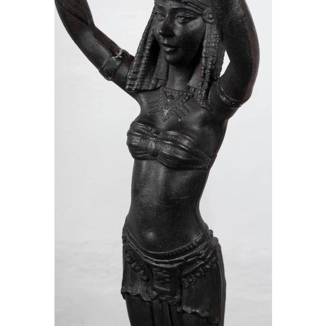 A stunning and incredibly rare Egyptian Revival table from the Art Deco period. Made of cast iron with a contrasting...