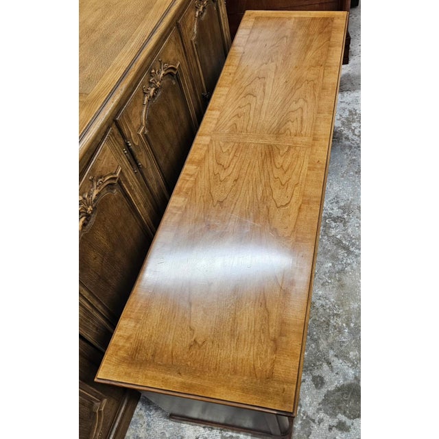 An elegant low credenza by Century Furniture, distinguished by its elongated silhouette, richly toned wood finish, and...