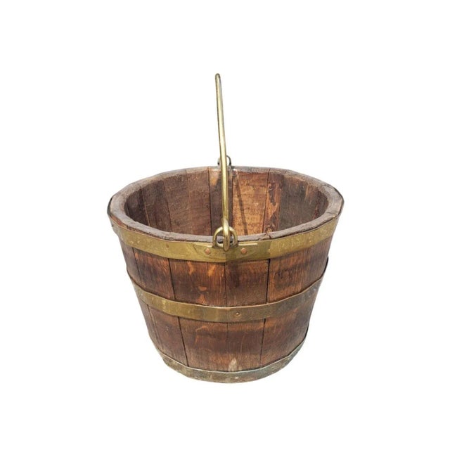 A 19th Century antique Brass Mounted And Oak Bail and brass Handle Bucket in very good antique condition. Measures 15" in...