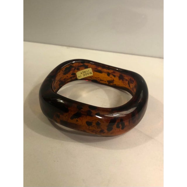 This fabulous Italian Lucite Tortoise Shell Abstract Bangle will soon become a favorite choice in your vintage jewelry...