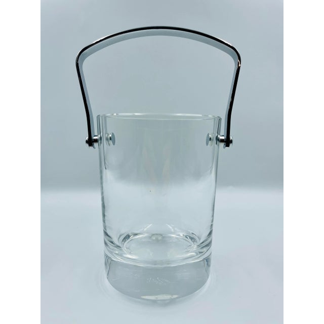 A stylish modernist crystal ice bucket perfect for tray table service or en-suite bar. This rare mid-century treasure from...