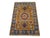 A warm rust field centers a bold Kazak medallion, surrounded by smaller motifs in blue, burgundy, cream, sage green, and...